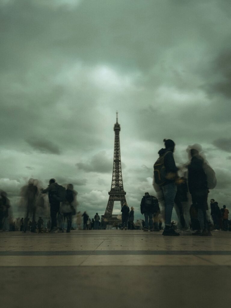 A group of people standing in front of the eiffel tower